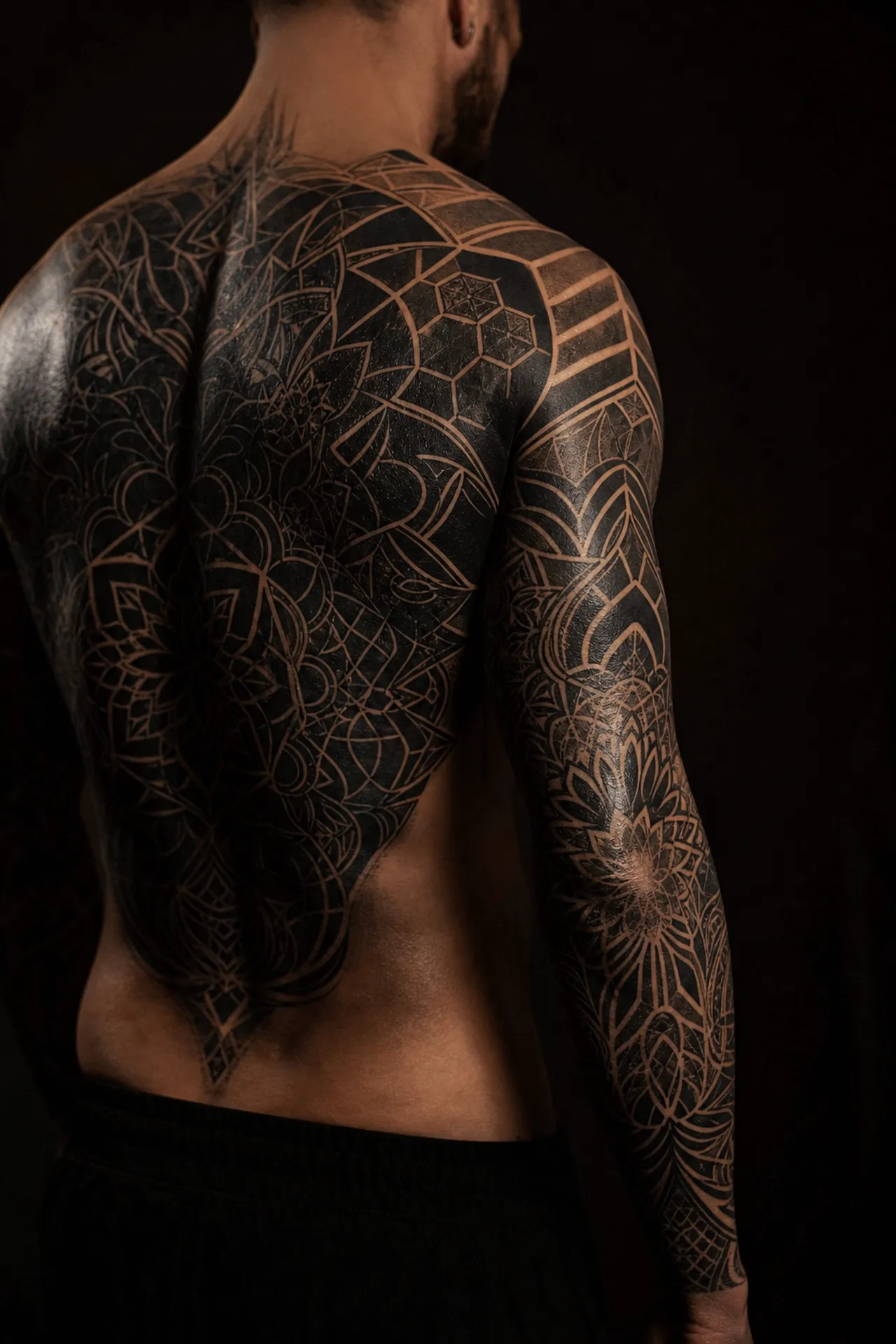 Illustrative image of a back and arms covered in black geometric and ornamental motifs.